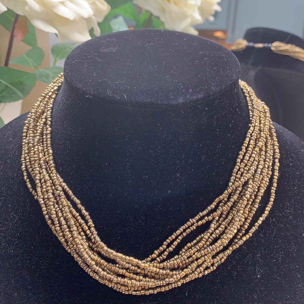 Layered gold copper metallic beaded necklace.